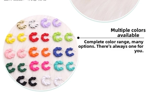 Macro shot of colorful twist C-shaped acrylic earrings on white faux fur background