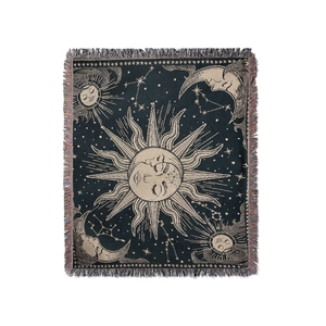 Detailed macro view of woven sun and moon patterns with colorful fringe on the throw blanket