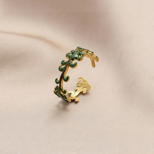 Detail of green enamel plant vine design on a gold-plated adjustable stainless steel ring
