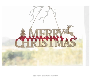Detail of wooden Merry Christmas ornament featuring reindeer and tree hanging on a white branch