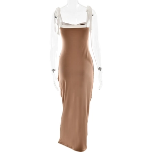 Detail of a brown maxi bodycon dress featuring elegant white shoulder tie ribbons