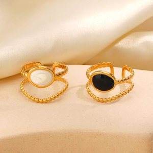 Retro 18K gold plated stainless steel geometric oval rings on a stone surface