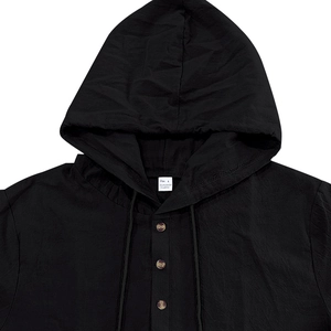 Detail view of the black linen hoodie neckline featuring functional button closures