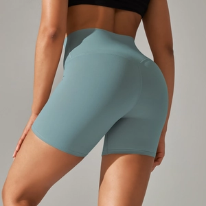 Detail view of high-waisted foggy blue yoga shorts showing elastic fabric and body-shaping fit