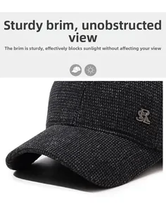Macro detail of dark grey wool blend texture and metal logo on a men's winter baseball cap