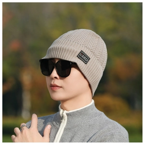 Detail of knit winter beanie featuring a FARDI woven label and ribbed texture