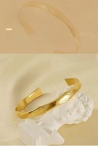 Detail of 18K gold plated stainless steel cuff bracelet with bamboo texture design