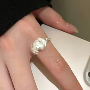 Gros plan d'une bague rotative en argent avec un design cinétique tournant sur le doigt