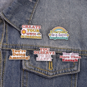 5pcs set of colorful inspirational enamel pins on denim jacket with motivational quotes