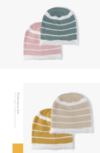 Close-up of multicolor striped knit beanie with soft plush texture and warm fuzzy finish