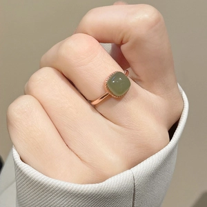 New Chinese retro square white jade ring with rose gold plating on a model's hand
