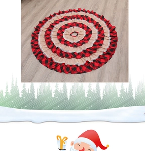 Close-up of burlap and red black plaid Christmas tree skirt with white lace edge