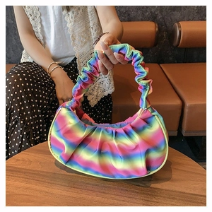 Detail of colorful rainbow gradient pleated shoulder bag featuring soft satin fabric texture