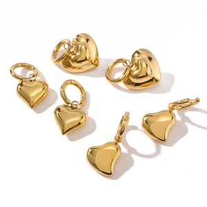 Polished hollow heart earrings in 18k gold plated stainless steel on white background