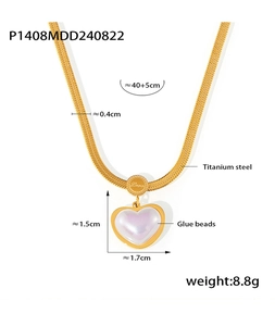 Detailed view of 18k gold heart pearl pendant on snake chain with Love engraving