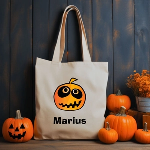Detail of canvas tote bag with Halloween pumpkin print and personalized Marius lettering