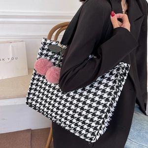 Large houndstooth canvas tote bag with pink cherry pendant shown on a model
