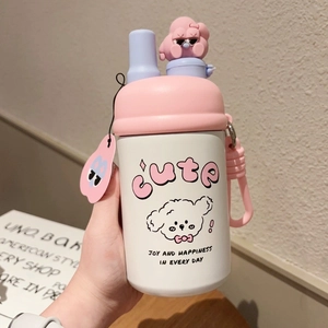 Detail of cute white insulated stainless steel cup with pink lid and puppy charm strap
