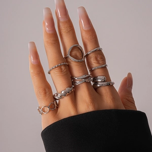 Close-up of 16-piece silver geometric ring set with hollow and twisted metal designs