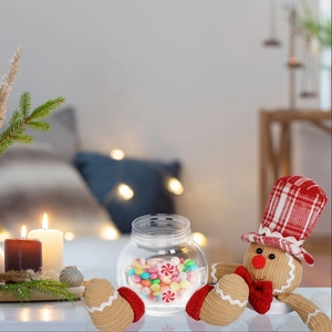 Sitting gingerbread man Christmas candy jar with festive holiday home decor and warm lights