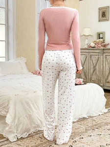 Rear view of pink long-sleeved pajamas with lace collar and crown print pants set