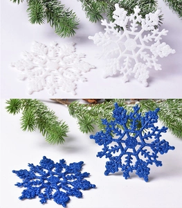 Detail of 10cm glitter snowflake ornaments in white and dark blue for holiday decoration