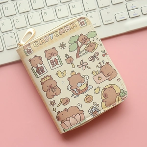 Close-up of beige capybara coin purse with zipper and cute cartoon print on pink desk
