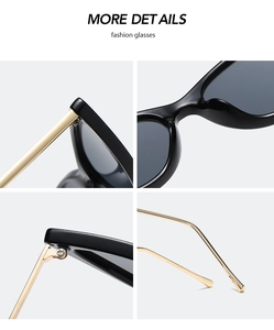 Macro view of black acetate frame hinges and gold metal temple tips on sunglasses