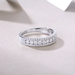 Macro shot of a triple-row sterling silver moissanite ring with size 7 engraving