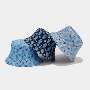 Three reversible bucket hats with vintage Hamsa and Evil Eye patterns in multiple colors