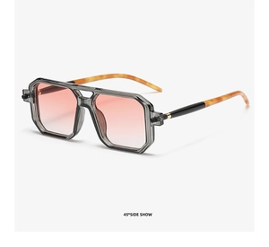 Detail view of double bridge sunglasses with orange gradient lenses and amber temples