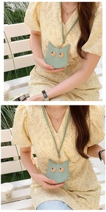 Detail of mint green cat-shaped mini PU leather neck pouch with crossbody strap