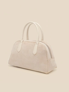 Minimalist beige suede bowling bag with a vintage retro aesthetic and top handles