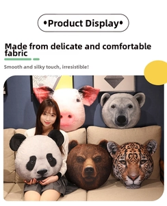Detail of soft plush animal head pillows featuring panda and pig designs on a sofa