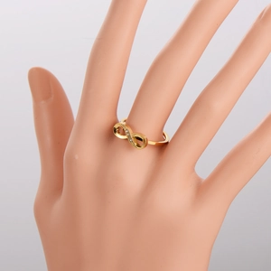 Infinity symbol gold ring with sparkling crystals on a model finger for women