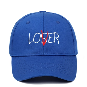 Close-up of Loser Lover text embroidery on blue cotton twill baseball cap fabric
