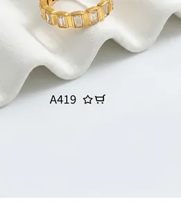 Detail of minimalist gold-plated ring featuring rectangle cubic zirconia stones