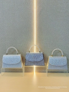Detailed view of rhinestone evening clutch bags in silver, gold, and black colors