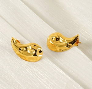 Detailed macro view of 18K gold plated teardrop earrings with a hammered liquid metal finish