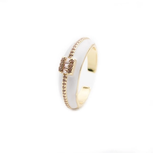 Detailed view of adjustable gold ring with white enamel and sparkling pave crystal inlay