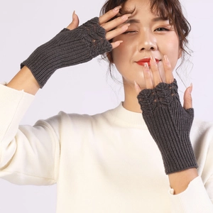 Detail of dark grey knitted fingerless gloves with elegant hollow fish scale pattern