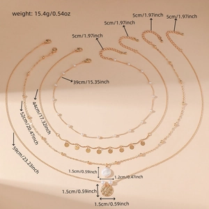 Detail view of layered gold necklace with sizing data, pearls and coin pendants