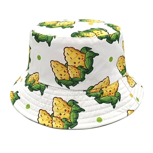 White cotton bucket hat with cartoon corn print and green leaf pattern for sun protection