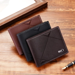 Short minimalist leather men's trifold wallets in black and brown on a wooden desk
