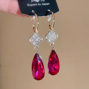 Rose gold clover earrings with a sparkling red teardrop gemstone pendant for women