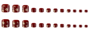 Detailed set of wine red fake toenails with golden glitter flower patterns on white background