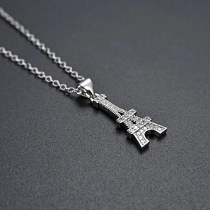 Close-up of silver Eiffel Tower necklace pendant with sparkling CZ diamond pavé detail