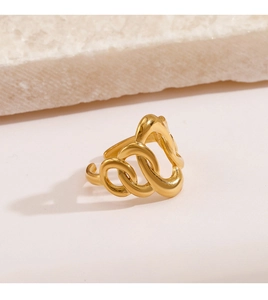 Macro shot of gold oval chain link ring on a textured stone display background