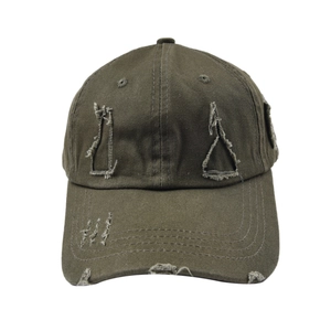 Close-up of distressed army green washed cotton baseball cap with torn vintage details