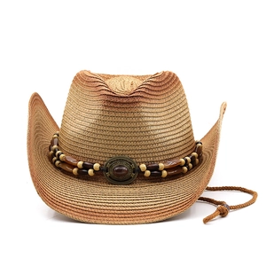 Detail of woven straw cowboy hat with vintage beaded band and turquoise gemstone buckle